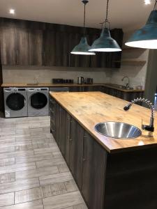 a kitchen with a sink and a washing machine at Forest Hill Wilderness in Wilderness