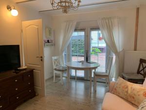 a living room with a table and a tv at Ferienwohnung in Werder Havel Innenstadt in Werder