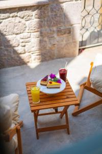 a table with a plate of food and drinks on it at Cundalis1893 in Ayvalık