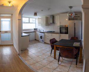 a kitchen with a table and a dining room at Very Spacious and beautiful 4-Bed House in London in London
