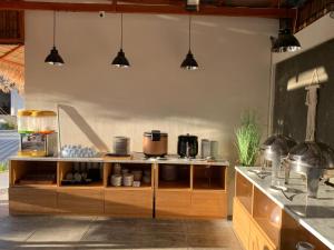 a kitchen with wooden cabinets and pots and pans at Shava Beach Resort in Gorontalo