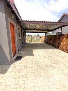 a patio of a house with a wooden fence at MV self-catering - Rooms in Bloemfontein