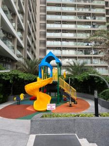 a playground with a slide in front of a building at Căn hộ The Sóng - Hedone home in Vung Tau