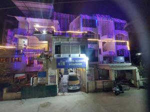 a building with purple lights on the front of it at Hotel Always Welcome in Mount Ābu