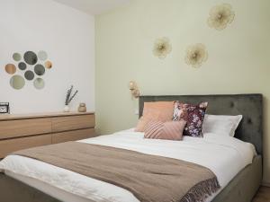 Un dormitorio con una cama grande con almohadas. en Cozy Nest Belvedere en Sibiu