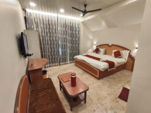 a hotel room with a bed and a tv at Hotel Always Welcome in Mount Ābu