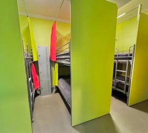 a room with green walls and bunk beds at Breeze Lodge in Brisbane