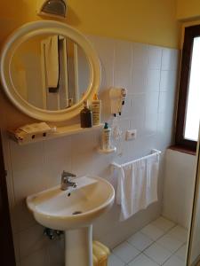 a bathroom with a sink and a mirror at CASA PATRIZIA MONTAIONE in Montaione