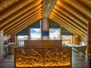 a room with a large pile of fire wood at Hotel Amerikan in Livigno