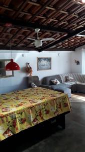 a bedroom with a bed and a couch at Casa Pousada Cantinho Secreto in Ubatuba