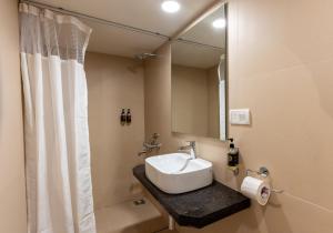 a bathroom with a sink and a mirror at Sunshine Resort Calangute Goa in Calangute