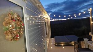 a christmas wreath on a balcony with lights at Livvi Rosa's Lodge in Newton on the Moor