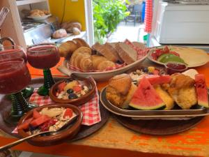 a table with plates of food and glasses of wine at SOEPP the B&B in Alkmaar