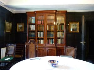 a dining room with a book shelf filled with books at The Hall in Penrith