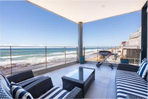 a balcony with chairs and a view of the beach at Sea La Vie - with Inverter in Umdloti