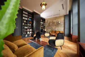 a living room with a couch and chairs at Hotel Victoria in Valence