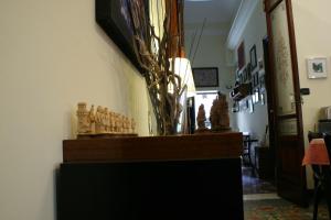 a room with a table with a vase on it at Casa Barbero Charme & Rooms in Catania