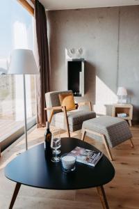 ein Wohnzimmer mit einem Tisch und einem Stuhl in der Unterkunft *Relax Apartment Hochgraßnitzberg* in den südsteirischen Weinbergen in Spielfeld