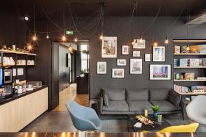 a living room with a couch and a table at Campanile Caen Centre Gare in Caen