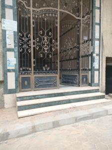 uma entrada para um edifício com um portão de ferro forjado em Family Friendly Appartement-Giza no Cairo