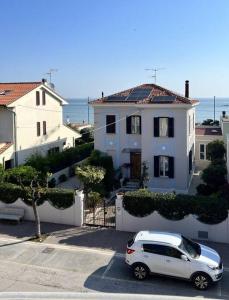 a white van parked in front of a house at Casa Corinaldesi in Marotta