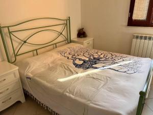 a bedroom with a bed with a metal frame at Casa Corinaldesi in Marotta