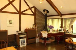 a living room with a table and a stove at ALBERGO DEL PESCATORE in Minamiaizu