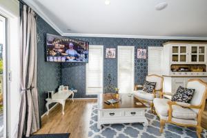 a living room with a couch and a tv at Kalani Retreat in Tauranga