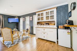 a kitchen with a white refrigerator and a table at Kalani Retreat in Tauranga