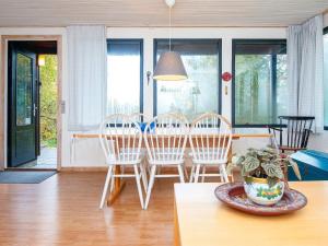 a dining room with a table and four chairs at 4 person holiday home in Silkeborg in Silkeborg