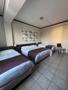 Postel nebo postele na pokoji v ubytování Hotel Vittoria + 2 fotografie