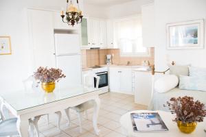a kitchen and living room with a table and a couch at Exilze House Beachfront Kionia in Kionia