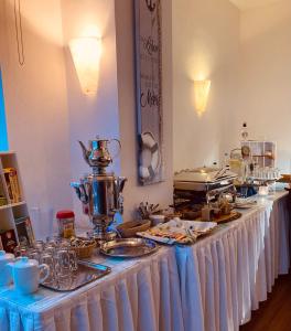 a buffet line with a table with food and drinks at Hotel Germania in Bansin