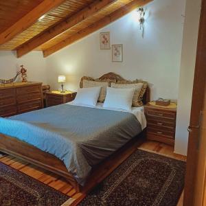 a bedroom with a large bed with two night stands at Cozy roof in Ioannina