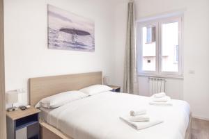 a bedroom with a large white bed and a window at Residence San Paolo in Rome