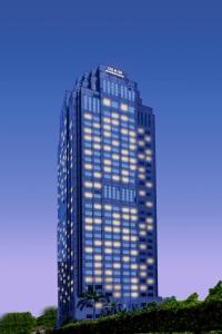 a tall blue building with lights on it at Dekin Hotel Chongqing Jiefangbei in Chongqing