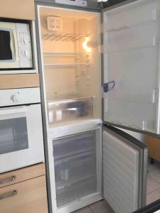 un frigorifero vuoto con la porta aperta in una cucina di Flat and garage near Rho-FieraMilano-MIND-Galeazzi a Pero