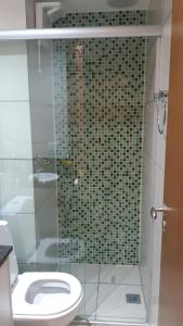 a bathroom with a glass shower with a toilet at Flat Asa Sul Condomínio Golden Place by CentoeDez in Brasília