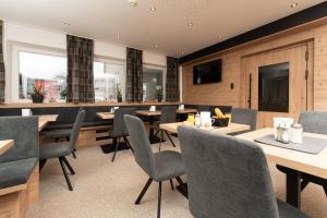 a dining room with wooden tables and chairs at Pension Sonnenheim in Sölden