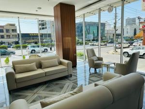 a living room with couches and chairs in a building at Motel Blue Corner 1 in Erbil
