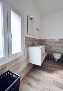 a bathroom with a white sink and a toilet at Macario Apartment in the Old Town in Bari