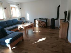 a living room with a couch and a fireplace at Ferienhaus am Kellpointhof in Miesbach