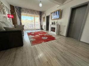 a living room with a couch and a fireplace at Downtown "Rendez-Vous" Luxury in Bacău