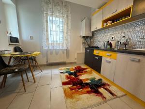 a kitchen with a table and a rug on the floor at Downtown "Rendez-Vous" Luxury in Bacău