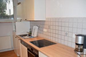a kitchen with a sink and a counter top at Work & Stay in Hagen in Hagen