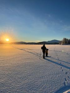 a person walking in the snow with a fire hydrant at Granlunda Fjällgård in Duved