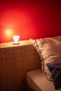 a bedroom with a red wall and a bed with a pillow at Set of Flats Vol 1 2 3 in Tríkala