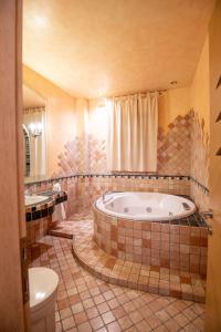 a large bathroom with a tub and a toilet at Set of Flats Vol 1 2 3 in Tríkala