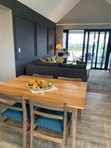 a table with a bowl of fruit on it in a living room at Pearl Valley - Unit 804 in Simondium