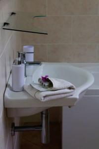 a white bathroom sink with a towel on it at Tra Mare e Pineta in Viareggio